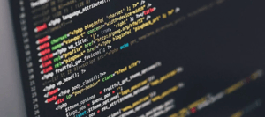 The image shows a computer screen with a lot of coding on a black background