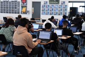 Students taking a digital assessment in a classroom setting