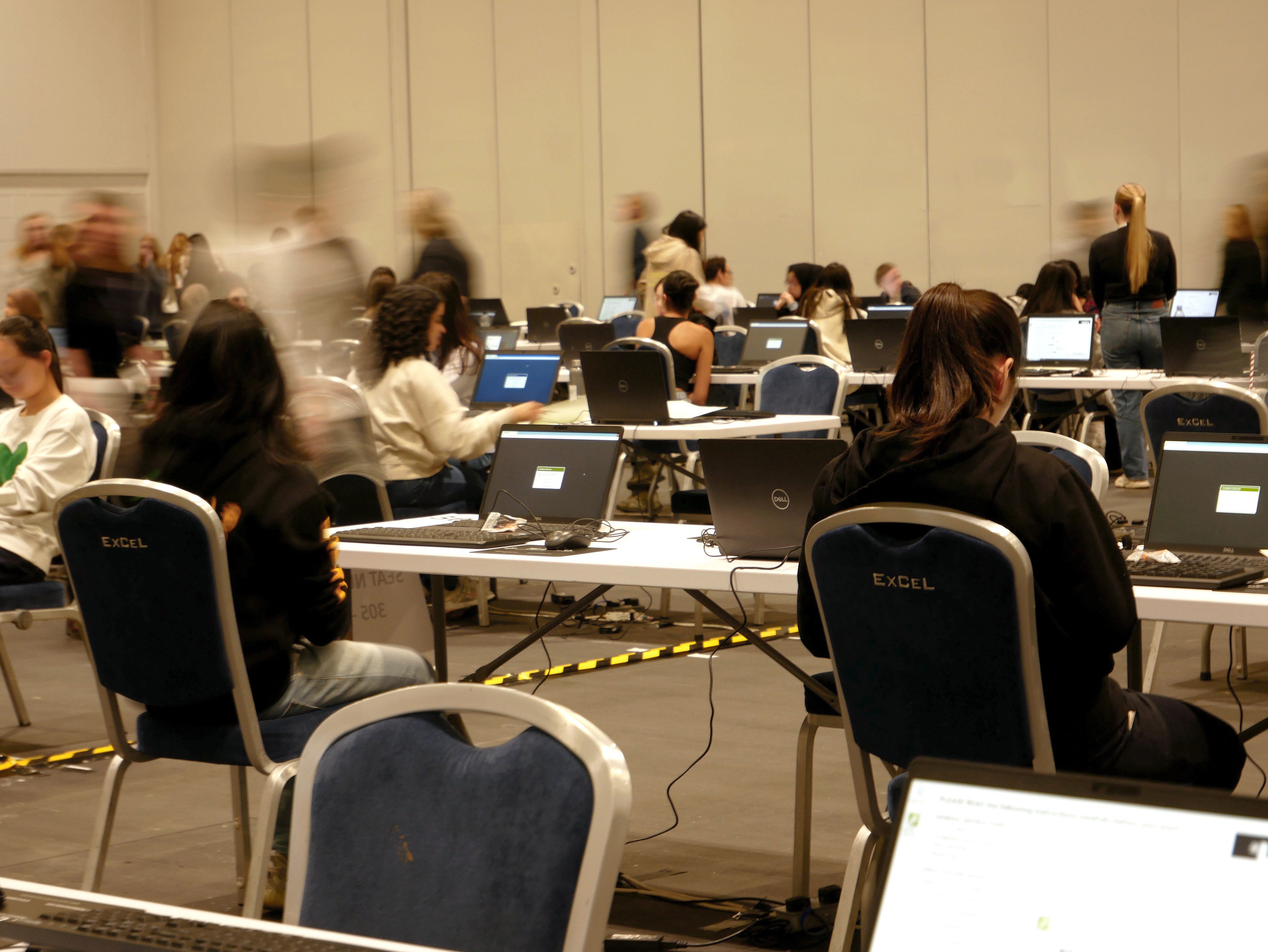 Exam Hall with Students Preparing for Exam with Laptops