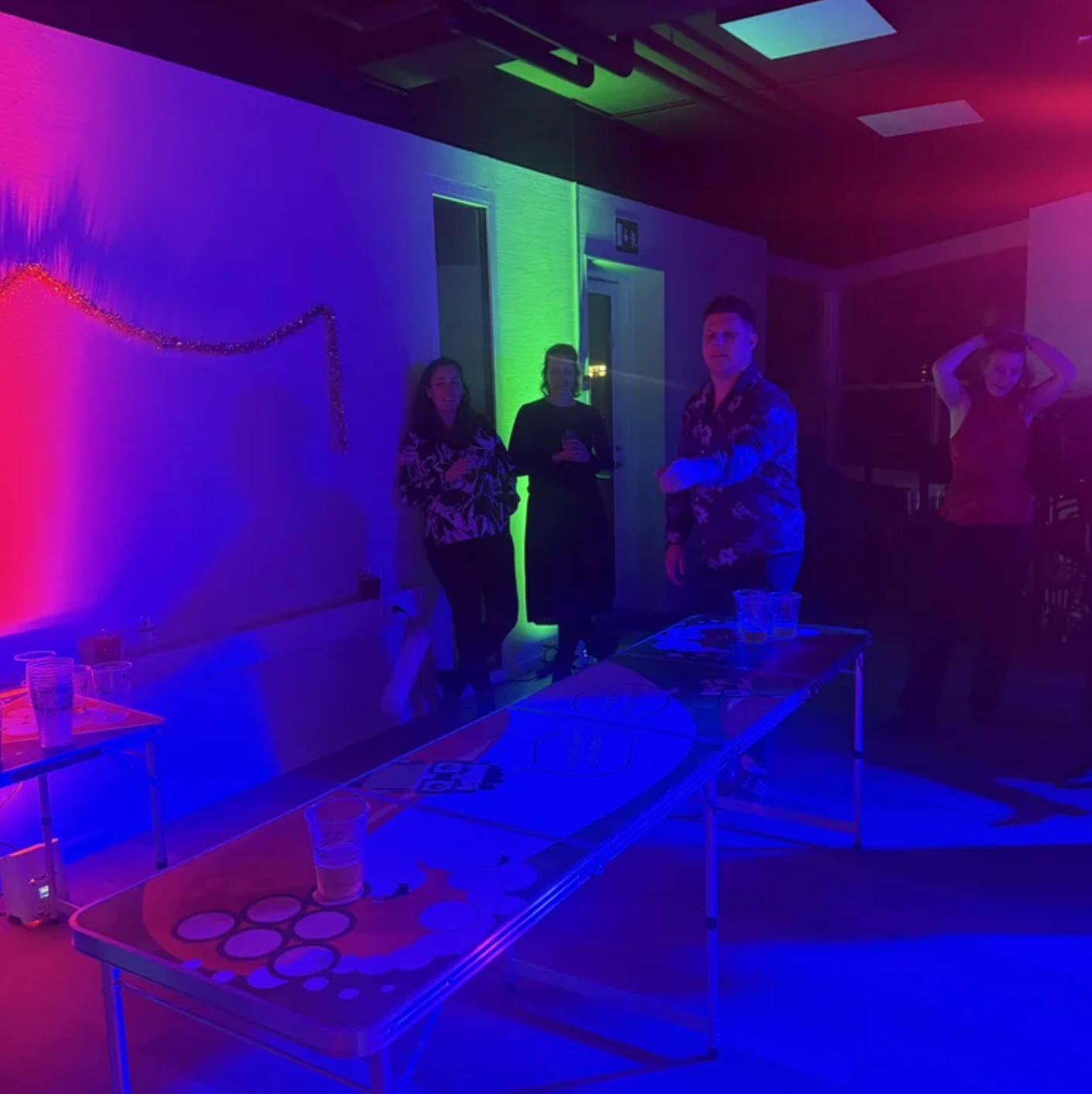 UNIwise employees playing beerpong at the Christmas party
