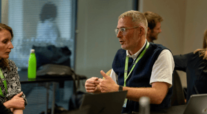 UNIwise employees talking to each other with a focus on Simon Hardaker
