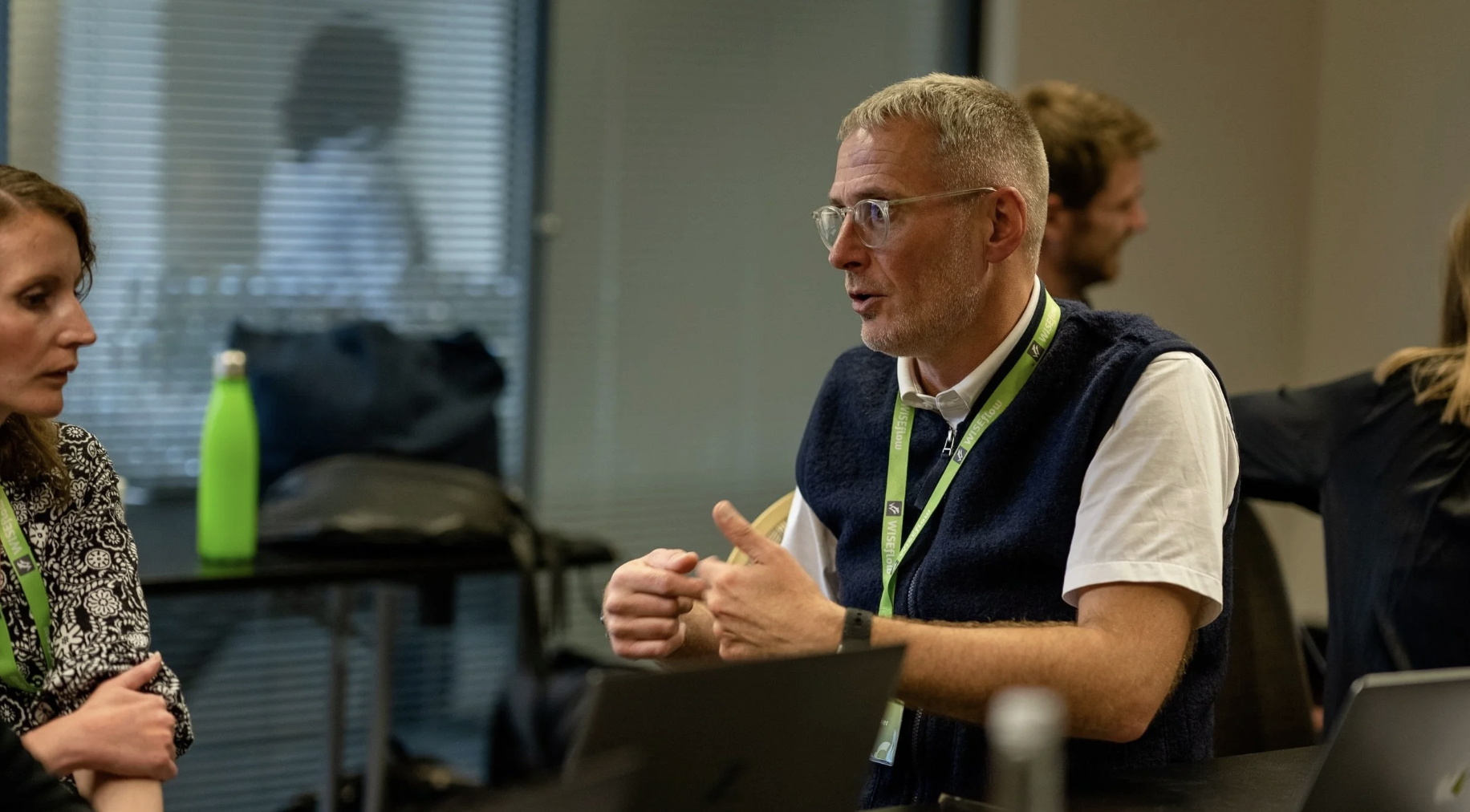 UNIwise employees talking to each other with a focus on Simon Hardaker