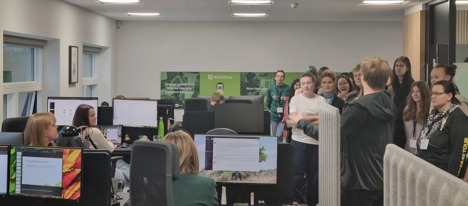 A gathering of employees getting a tour of the UNIwise offices