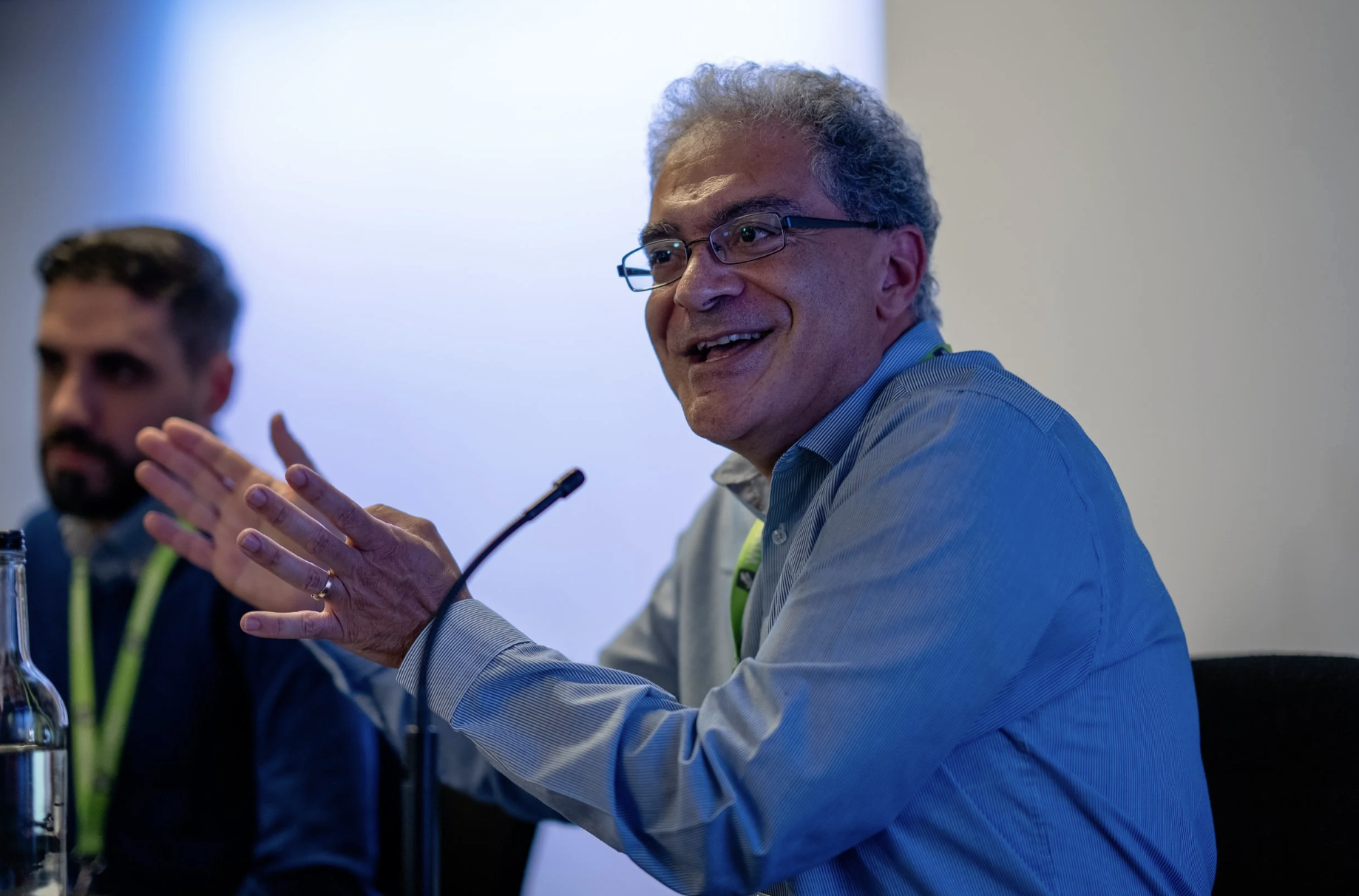 Speaker at WISEcon22 talking into a microphone about EdTech and digital assessment
