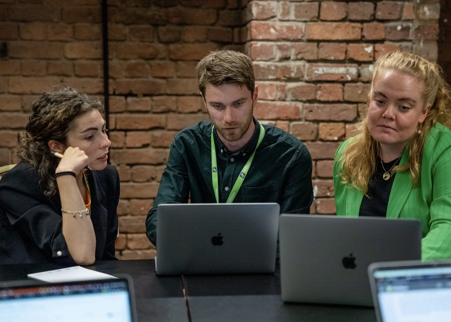 Attendees of WISEcon22 looking at software on laptops